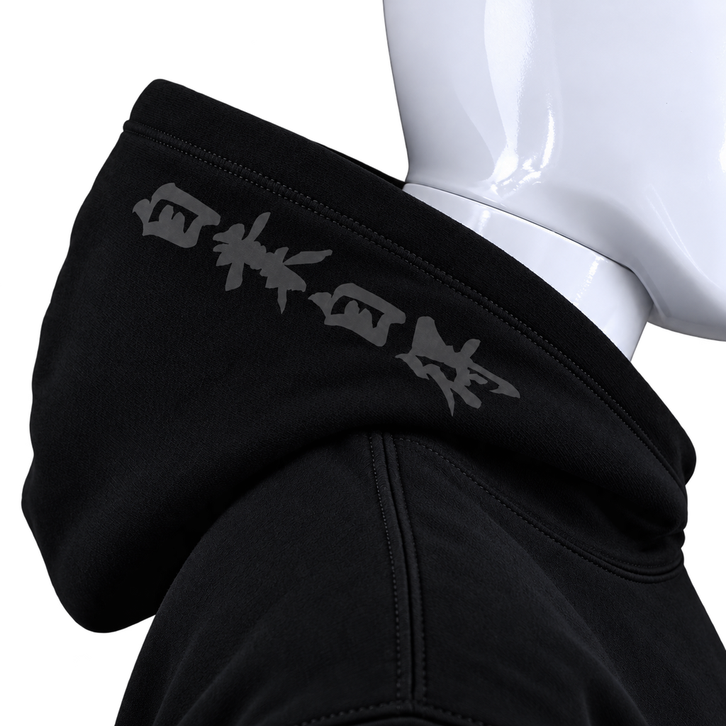 Close-up of a black hoodie on a white mannequin torso, showing the hood with gray stylized text across the collar.